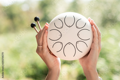 Woman Playing Steel Tongue Drum for Mindfulness and Relaxation