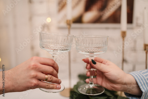 Cuadro en lienzo Male and female hands holding glass champagne coupes, celebratory toast