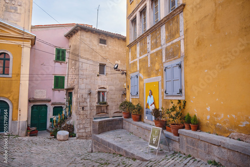 Scenic views of old town Labin in Istria, Croatia. Historic stone houses, tiled roofs, church facade, cozy narrow streets,