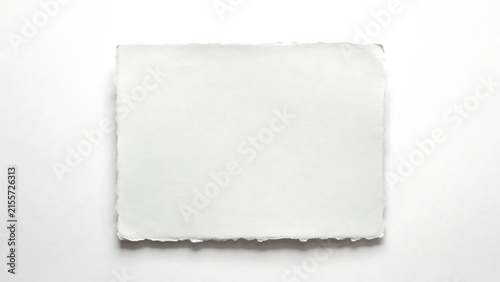 A sheet of handmade paper with deckled edges isolated on white background