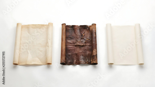 Three different types of scrolls isolated on white background, showing a progression from aged parchment to weathered bark and clean modern paper
