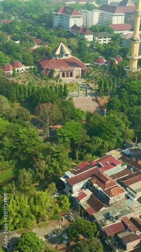 Vertical aerial view of mosque complex within green Yogyakarta neighborhood
