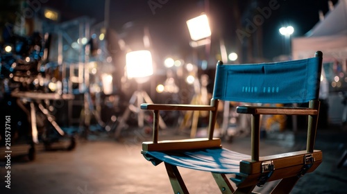 Empty director's chair on a professional film set with studio lighting, camera equipment, and production gear for movie and television production