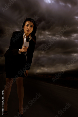 Full length of news reporter in storm 