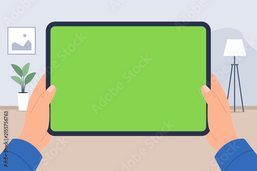 Hands holding a tablet with a green screen in a modern interior, ideal for technology mockups, digital advertising, app presentation, screen replacement, and online marketing.