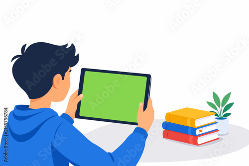 Young man holding a tablet with a green screen at home, perfect for digital device mockups, technology concepts, online learning, advertising, marketing, and modern lifestyle designs.