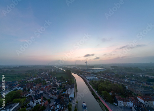 Lot, Beersel, Vlaams-Brabant, 22nd of April, 2025, A peaceful aerial landscape beautifully showcasing a winding river amidst lush greenery under a tranquil twilight sky
