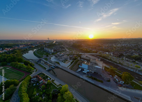Halle, Vlaams Brabant, Belgium, 27th of April, 2025, An absolutely stunning aerial view beautifully showcasing a picturesque sunset over a winding and tranquil river