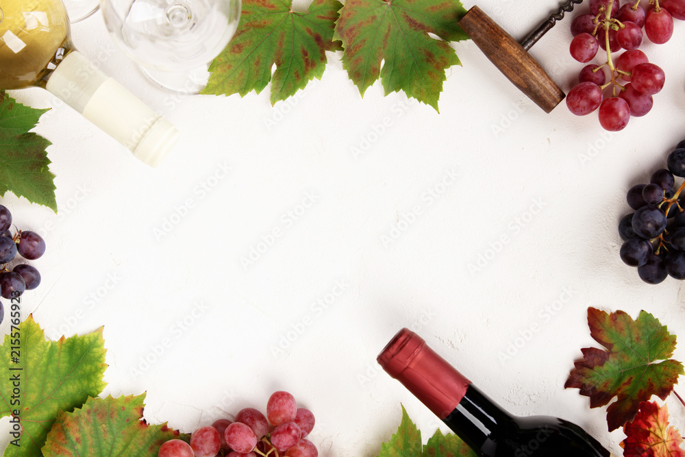 Naklejka premium Wine Bottles and Grapes on White Background with Copy Space