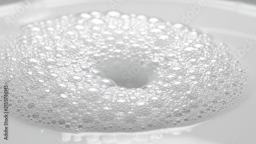 White Soap Foam and Suds Expanding Across Clean Surface