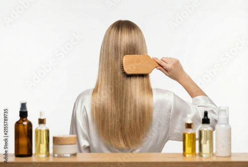 An Indoor Scene Where Woman Gently Cares For Her Hair Using Nourishing Oils And Brushes
