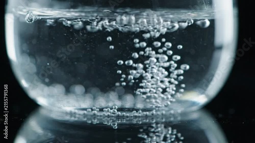 Effervescent Bubbles Rising Continuously in Clear Sparkling Mineral Water Glass
