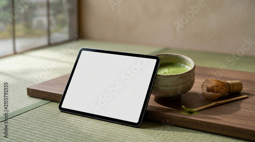 Macro close up of blank tablet and matcha tea on wooden desk.