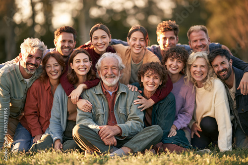 Family portrait multigenerational outdoor happy smiling close group embrace warm sunlight