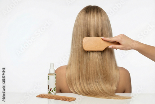 Woman Nourishing Her Hair With Natural Botanical Oil During Relaxing Hair Care Ritual