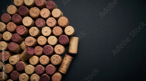 A bunch of wine corks arranged on a dark background