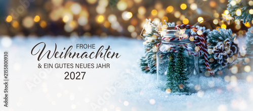 Christmas greeting card with German text Frohe Weihnachten und ein gutes neues Jahr 2027 - Beautiful xmas decoration with Christmas tree in snow - Background banner
