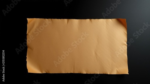 A torn piece of aged paper with a textured surface rests on a smooth black background.
