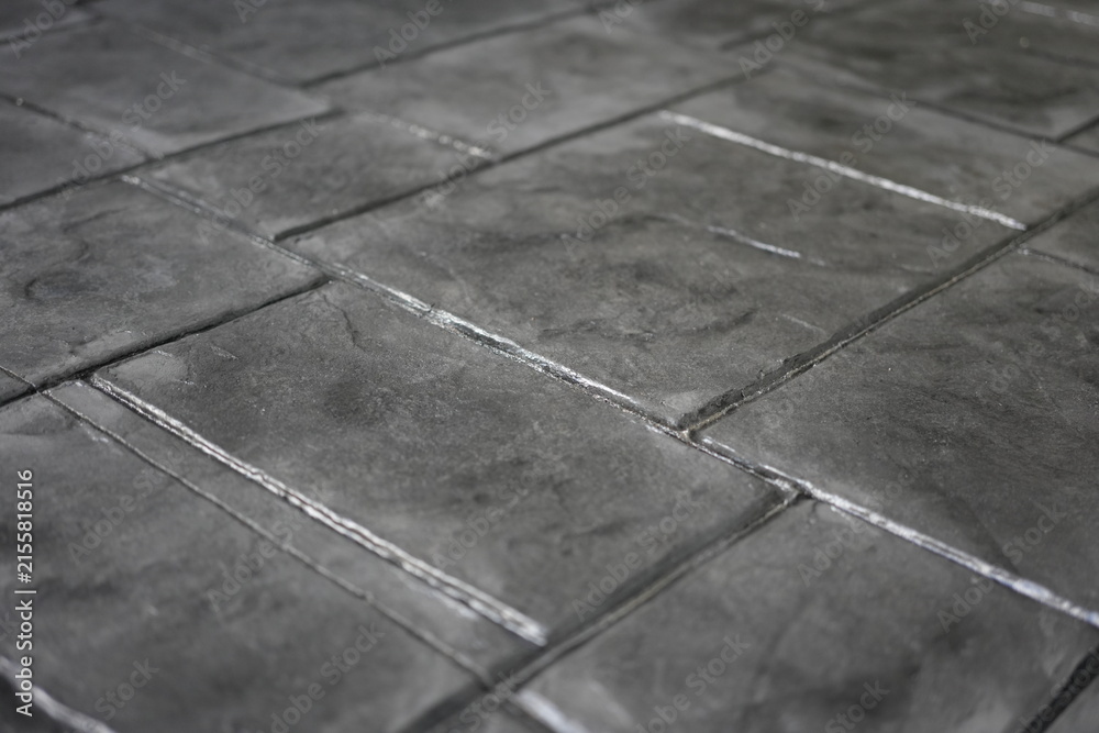 Fototapeta premium The concrete floor features beautiful patterns and intricate textures, distinguished by elegant geometric details and exquisite craftsmanship, creating a unique and visually appealing surface.