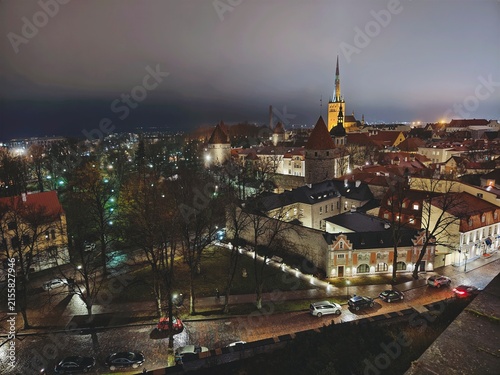 High angle illuminated night view of Tallinn old town skyline and historic architecture in Estonia.