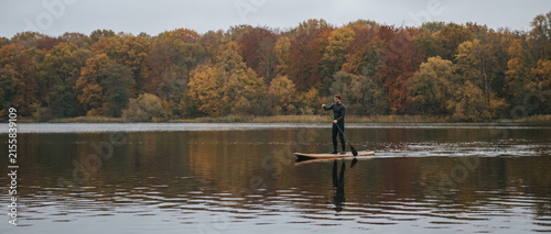 Early-autumn paddle boarding on a European lake