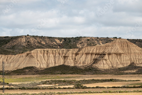 фотографія Eroded Badlands and Farmland in the Bardenas Reales, Navarra, Spain