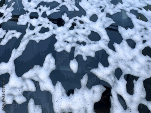 Abstract Soap Foam Pattern on Dark Car Surface