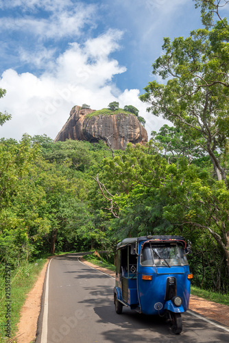 Local tuk-tuk riding tourists at Sigiriya Lion Rock, near Dambulla, Central Province, Sri Lanka	
