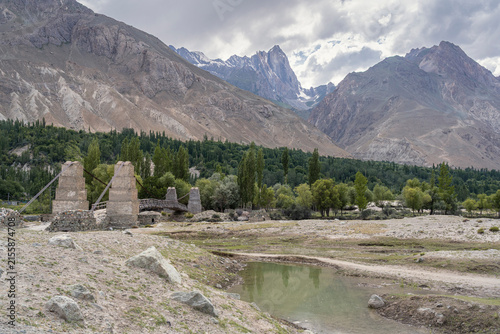 Scenic summer landscape view of bridge in Shigar river valley under moody sky, Shigar, Gilgit Baltistan, Pakistan