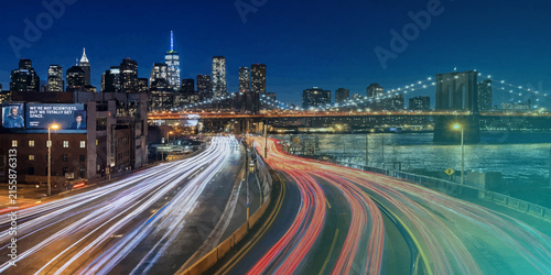 Long exposure night traffic on metropolitan highway interchange with exposure transportation downtown metropolis infrastructure vehicles velocity movement skyscrapers architecture nighttime