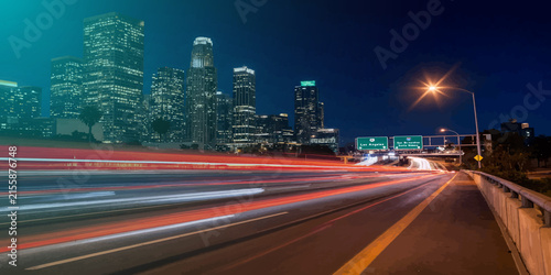 Long exposure night traffic on metropolitan highway interchange with exposure transportation downtown metropolis infrastructure vehicles velocity movement skyscrapers architecture nighttime