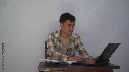 Focused Student Engaged in Learning at Modern Workspace with Laptop and Study Materials, Capturing the Essence of Education and Personal Growth