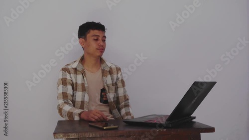 Engaging Virtual Discussion with Enthusiastic Young Man Displaying Dynamic Gestures while Using Laptop
