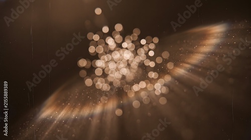 Circular golden light flare with central bokeh and dust