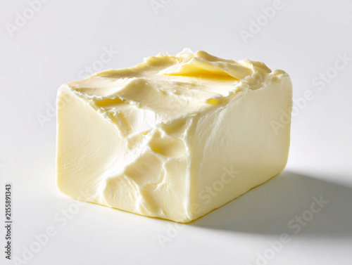 Fresh butter block isolated on a clean white background, studio product photography with high-key lighting, minimalist design, and photorealistic detail. 