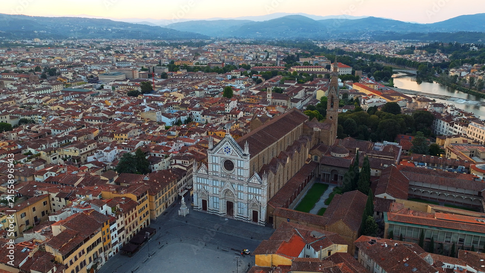 Fototapeta premium Basilica Santa Croce square Florence high aerial drone view Italy Tuscany cityscape Arno river travel vacation background commercial stock photo horizontal