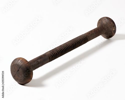 Rusty, old-fashioned screw with knurled ends against white background.