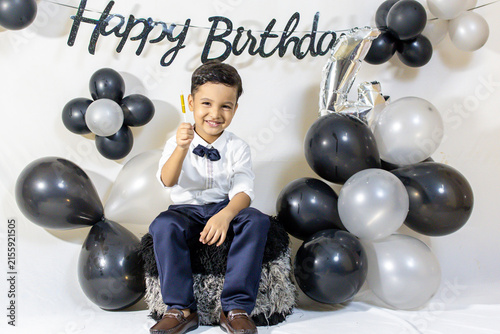 Little Boy in Formal Shirt and Bow Tie Celebrating His fourth Birthday Indoors