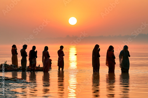 Devotees Performing Chhath Puja at Sunrise in River, India