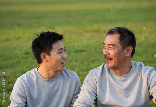 Asian father and adult son ...