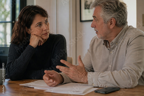 two adult family members having a serious but supportive conversation at home