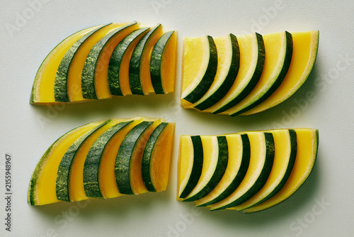 Vibrantly sliced yellow squash arranged artistically for culinary presentation.