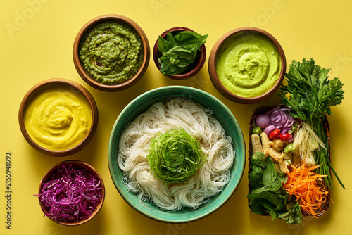 A vibrant assortment of fresh ingredients and sauces for a colorful culinary experience.
