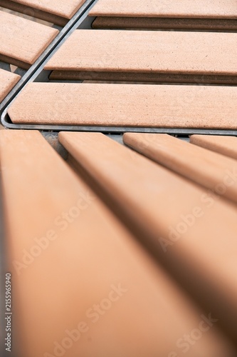 Close up of composite wood decking planks on steel frame with selective focus and diagonal perspective