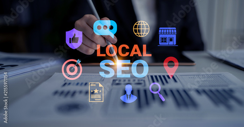 Fotografía A business professional focuses on local SEO strategy using a pen, surrounded by marketing icons on an office desk