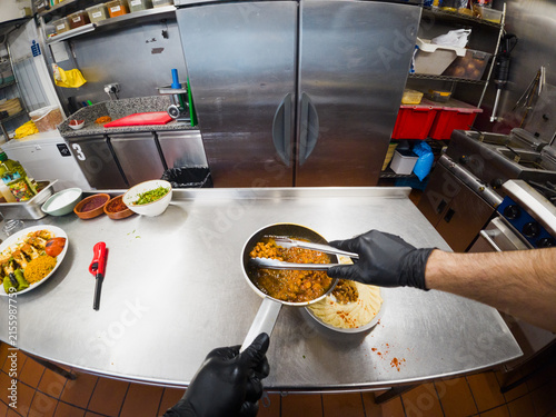 POV of chef plating curry