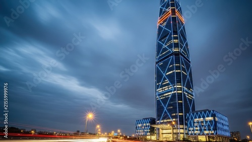 Illuminated modern skyscraper architectural design at night.