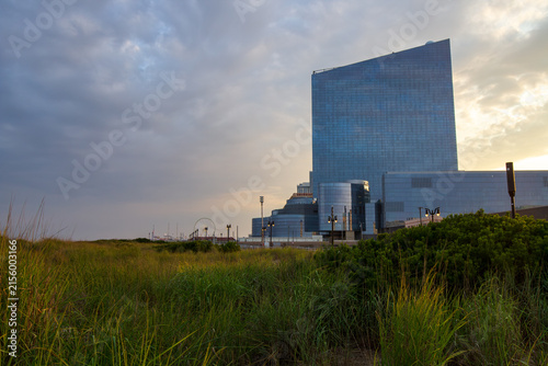 Atlantic City, New Jersey, USA - July 22, 2026: The massive glass tower of Ocean Casino Resort rising behind coastal dunes and beach grass under a late afternoon sky.