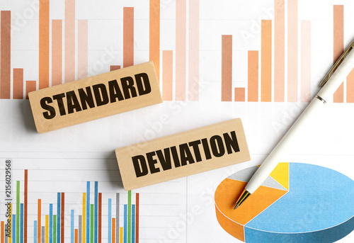 Konstfotografi Standard deviation concept with wooden blocks, financial charts and pen, represe