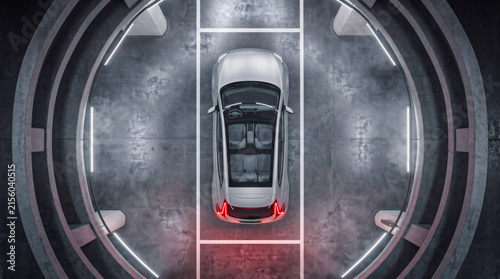 Top view of a futuristic autonomous electric car in a high-tech parking facility.